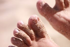 feet in the sand in the sun