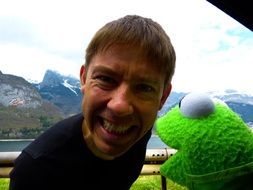 cheerful laughing man with a bright toy