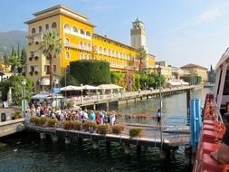 landscape of tourists walk across the bridge in a colorful city