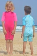 contrast blue boy and pink girl on beach