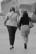 two women walking away