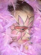 pink face painted on a child's face