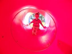 the girl plays in a children's tube