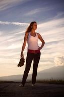 girl with shoes in hand on the highway