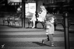 black and white photo of a child in the street
