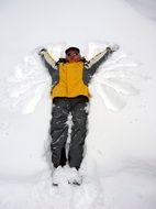 man lies in the snow