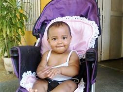 black baby in a purple stroller