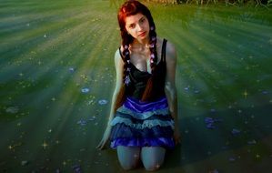Beauty of girl with long hair on a background of lake with flowers