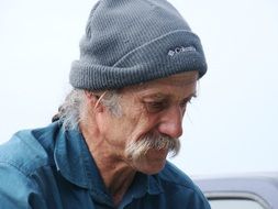 fisherman in a gray hat