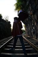 guitarist is standing on railroad tracks in Sri Lanka