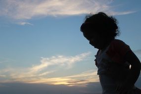 silhouette of a child at sunset in salvador