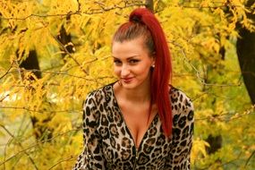 portrait of a girl on a background of yellow autumn leaves