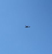 silhouette of a helicopter in the sky