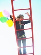 girl on ladder with balloons