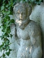 bearded man, aged stone sculpture at wall