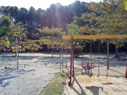 child on swing in park