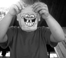 photo of a child with a spongebob mask, black and white