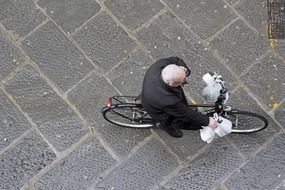 elderly man cycling in the square