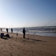 silhouette of fishermen at sea