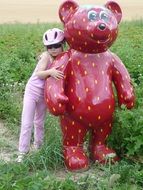 child and statue red bear