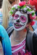 man with painted face in a street parade