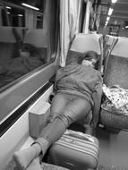 man in train calm sleeping