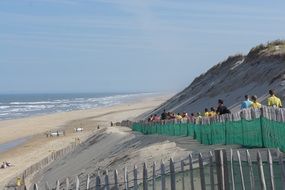 People on the dune on the beach