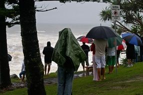 people on the beach during the rain