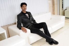 cool man in black sitting in white interior