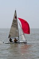 two people on a sailing boat in the bright sun