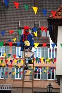 colorful flags and a clown on the street in a parade in Germany
