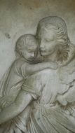 statue of mother with baby in a graveyard closeup