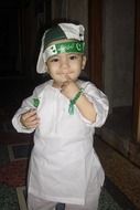 little boy in a white suit and cap