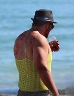 dressed young man with drink