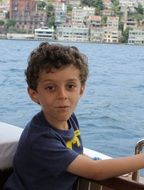 baby with curly hair on the boat