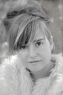 photo of a girl with a high hairstyle and a white fur coat