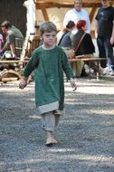 middle ages costumed child boy walking barefoot