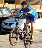 young boy doing tricks on a bicycle