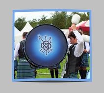 Scotsman plays on a blue base-drum