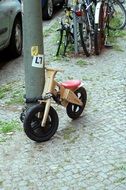 children bicycle is parked on the promenade
