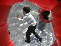 children play in a hamster ball