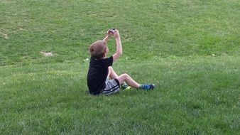 boy with a camera on the lawn