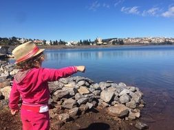 little girl on the pond