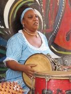 the afro-cuban woman plays on a bongo