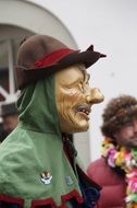 man in wooden mask and hat