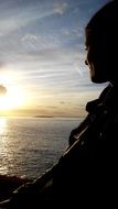 man watching the sea sunset