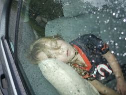 portrait of sleeping young girl in car