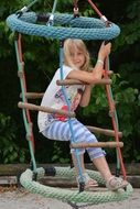 little girl riding a swing