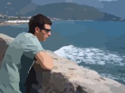 man in sunglasses looks at the ocean