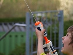 child playing with a water gun